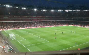 A mostly full night time Emirates Stadium.