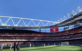 Inside Emirates Stadium with a blue sky.