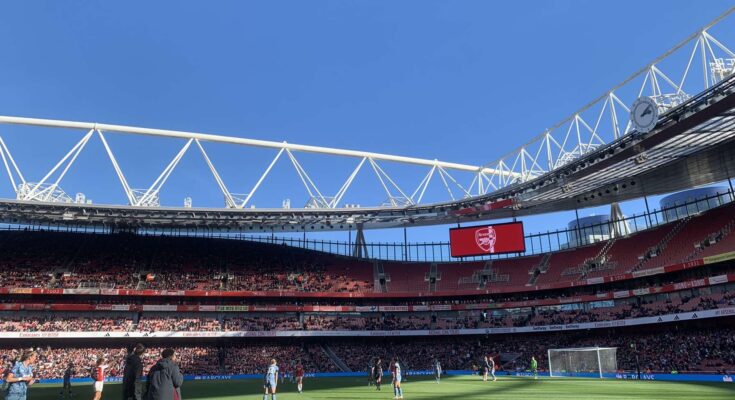 Inside Emirates Stadium with a blue sky.