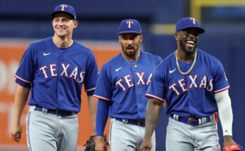 Pictured: Corey Seager, Marcus Semien and Adolis Garcia walking before a Texas Rangers game
