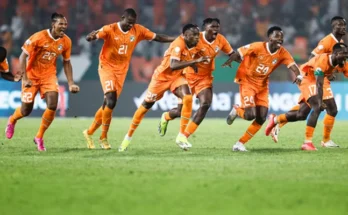 Ivory Coast players running from the half-way line to celebrate after Kessie scored the winning penalty.