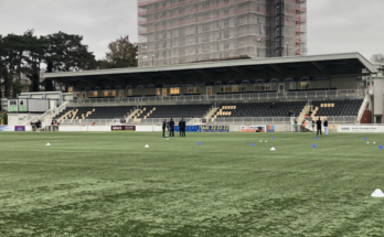 The main stand at Maidstone United. The stand contains black and yellow seats