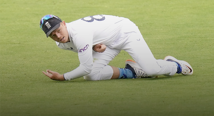 England vice-captian Ollie Pope on the grass after fielding the ball