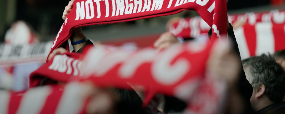 Fan holding up football scarf for Nottingham Forest