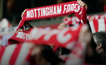 Fan holding up football scarf for Nottingham Forest