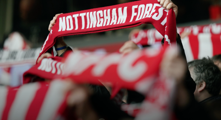 Fan holding up football scarf for Nottingham Forest