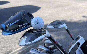 A golf ball and several golf clubs.