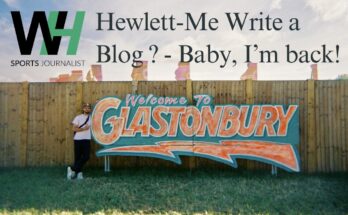 Hewlett-Me Write A Blog? - Baby, I'm back! Will Hewlett stood next to an orange and green 'Glastonbury' sign.