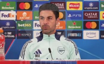 Mikel Arteta sitting at a press conference ahead of Arsenal's clash with PSG
