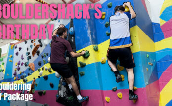 Two men climbing on a brightly coloured wall. With pink text that says 'Bouldershack's Birthday' and white text that says 'Bouldering TV Package'