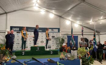 Rosie Edwards stands on top of the podium.