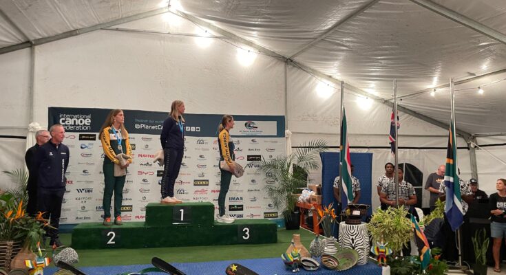 Rosie Edwards stands on top of the podium.