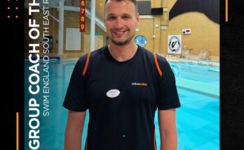 Coach having photo tae for coach of the year in front of a diving pool