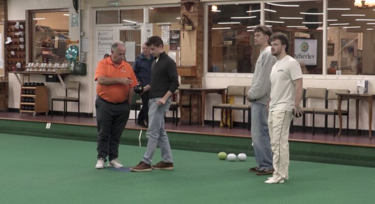 Atherley Bowls showing young students how to play the sport.