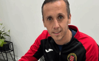 Winchester City manager Craig Davis signs his new contract