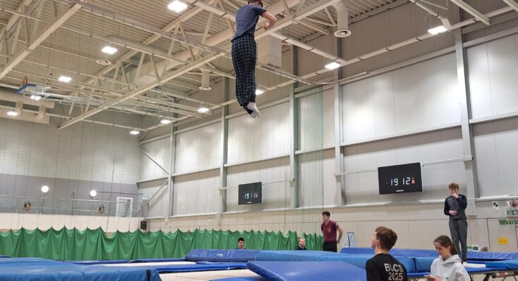 A man mid-air after jumping on a trampoline