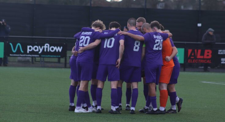 AFC Stoneham players huddled together before kick-off