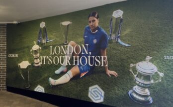 Sam Kerr surrounded by Chelsea Women's trophies.