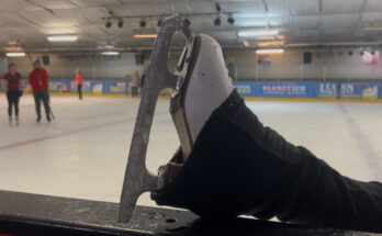 An ice skating boot on a ledge