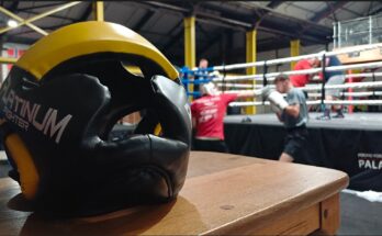 boxing helmet infront of man punching