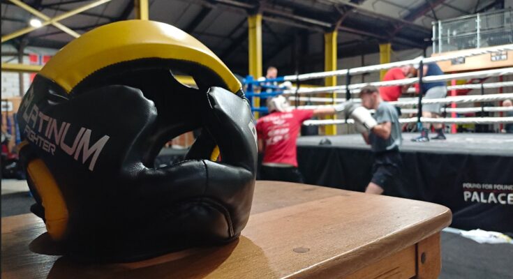 boxing helmet infront of man punching