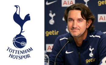 Tottenham Hotspur manager Thomas Frank sat at a press conference next to an image of the club badge.