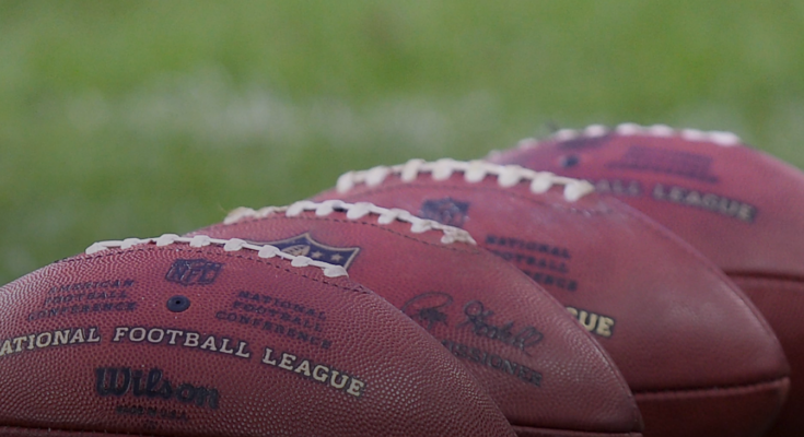NFL balls in training action.
