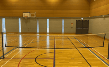 Badminton net on with multi-use hall lines
