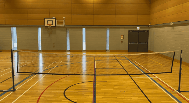 Badminton net on with multi-use hall lines