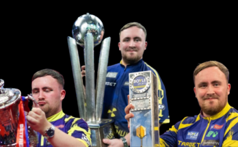 A Darts player in a purple and yellow shirt holding three trophies.