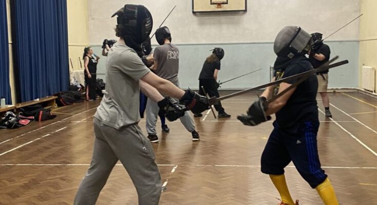 Two fencers taking part in historical fencing