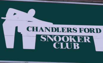 Green snooker club sign on brick wall