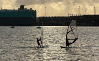 Shot of windsurfers as the sun sets